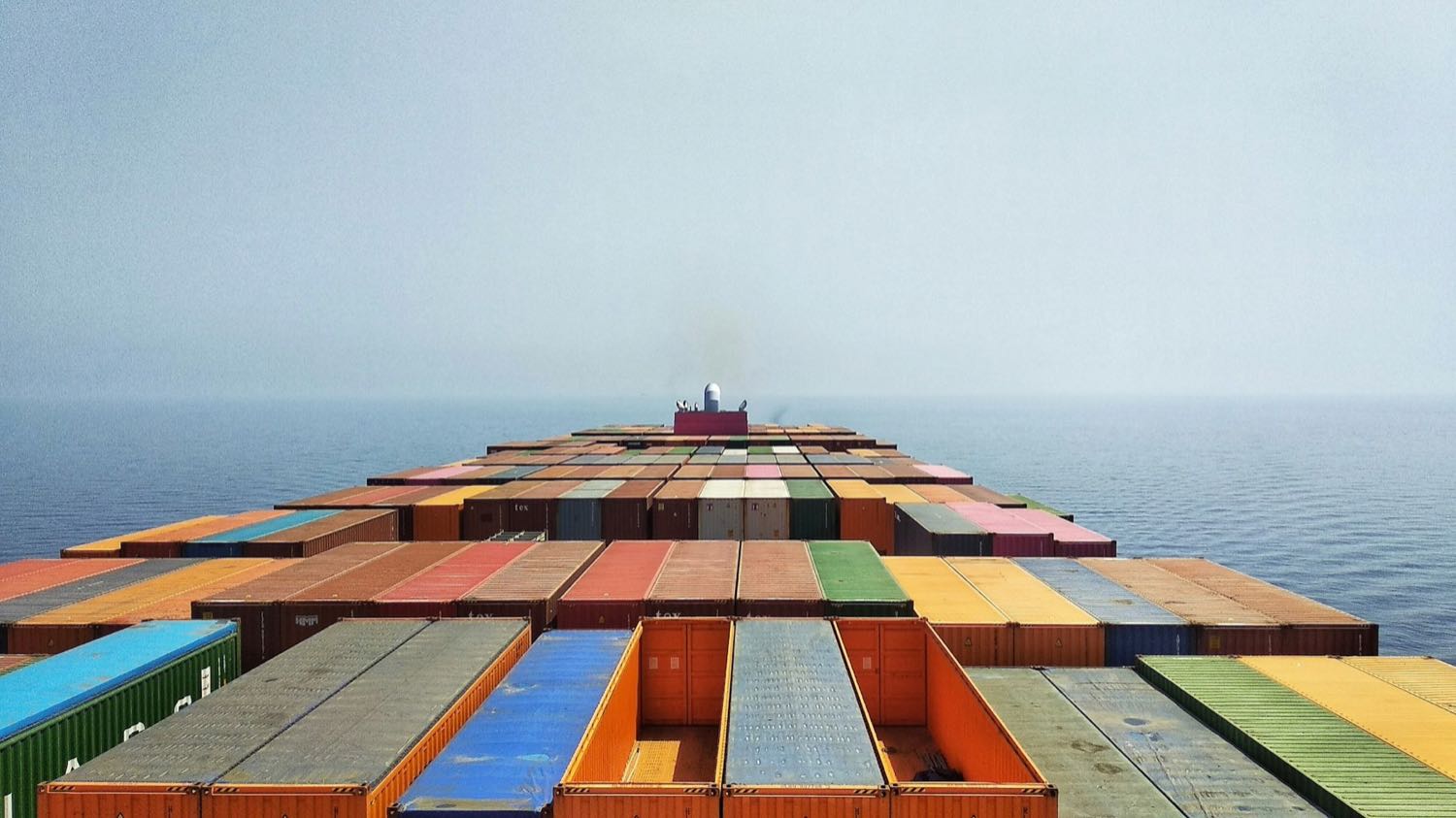 View along the deck of a fully-laden container vessel at sea